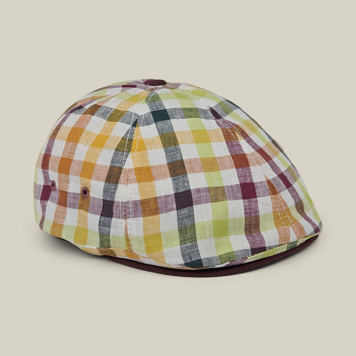 The Goorin Bros. “Point Lobos” is a 6 Panel Ivy flat cap, handmade in the USA from a breathable cotton blend, featuring a multicolored plaid design with yellow, green, burgundy, and white squares, and displayed on a neutral background.