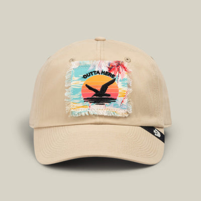 The “GTFO” cap by Goorin Bros. features a beige design with a frayed patch depicting a sunset, palm trees, and the words “Outta Here” above a black bird silhouette—just the thing for channeling those S.O.S. Island vibes, whether you’re off to the mess hall or simply daydreaming about your next adventure.