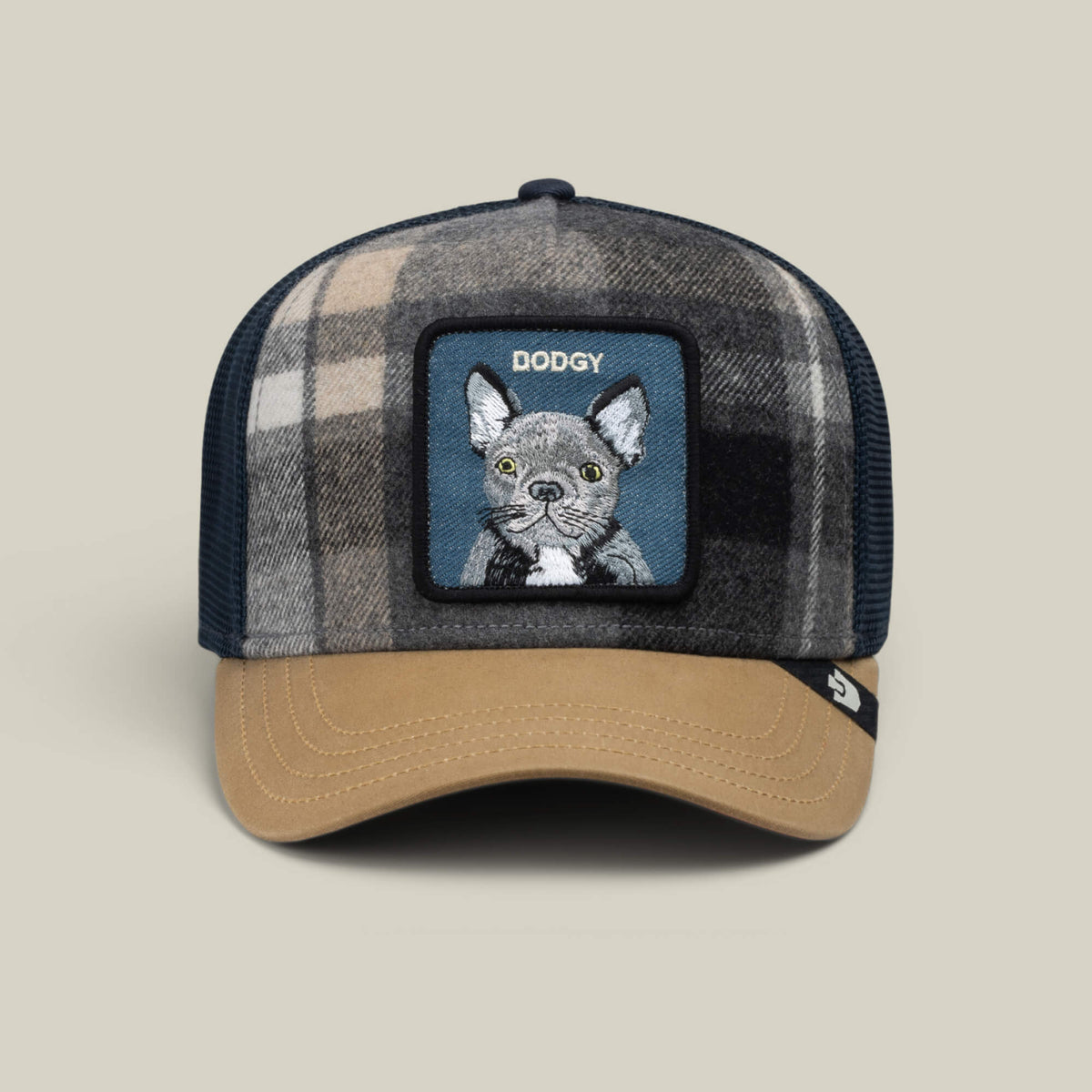 The Brit Frenchie cap by Goorin Bros. is a plaid adjustable hat with a tan brim that features a dog patch labeled DODGY on the front—making it the perfect casual accessory for any Frenchie fan.