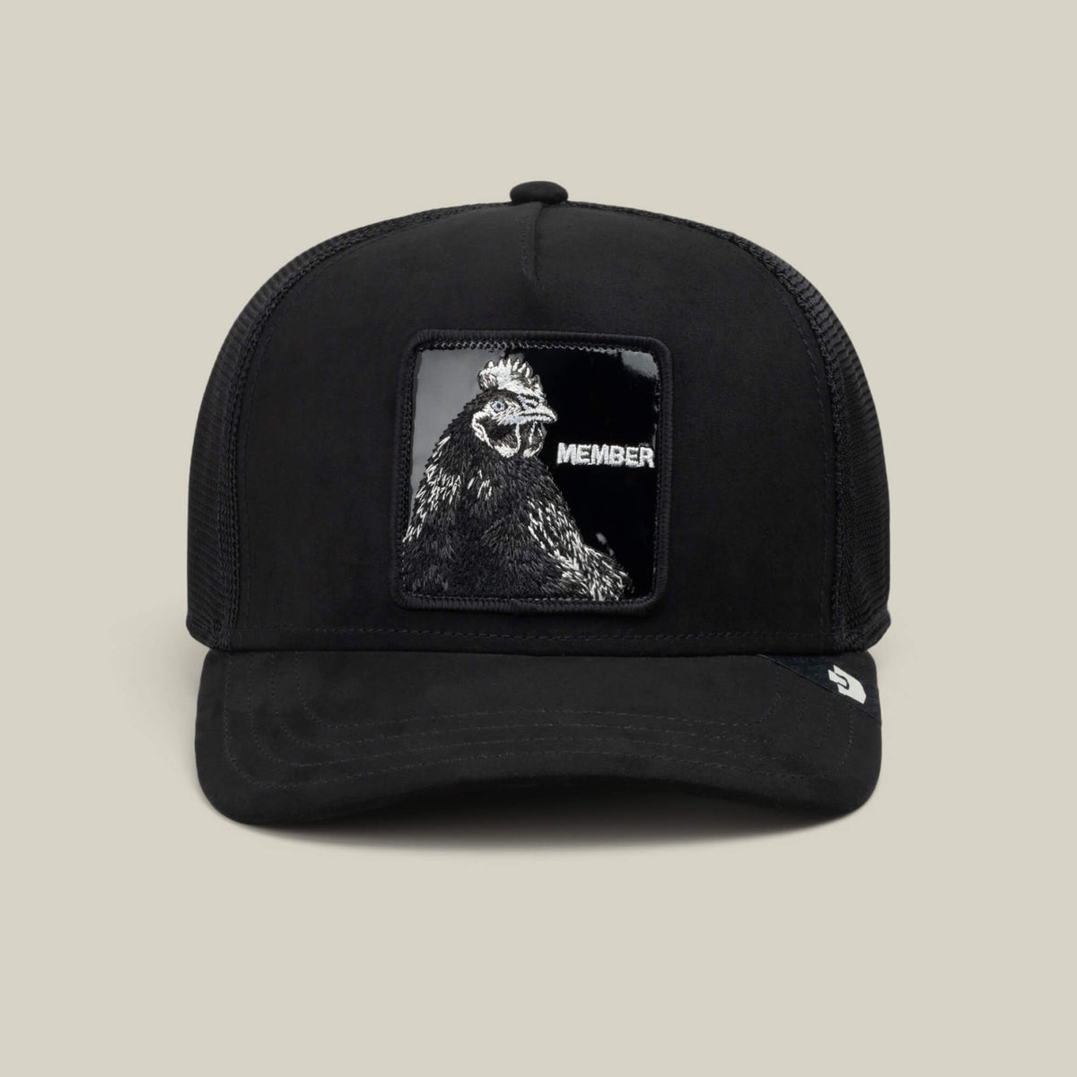 Goorin Bros. Black Out Rooster trucker hat crafted from jet-black polyester with a mesh back, featuring a MEMBER patch and striking rooster artwork on the front panel. Pair it with the Blackout Rooster slides for a perfectly coordinated look.