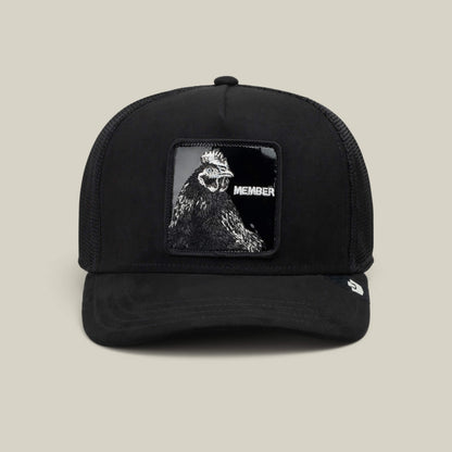 Goorin Bros. Black Out Rooster trucker hat crafted from jet-black polyester with a mesh back, featuring a MEMBER patch and striking rooster artwork on the front panel. Pair it with the Blackout Rooster slides for a perfectly coordinated look.