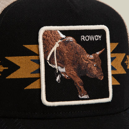 The Canyon Rowdy trucker hat by Goorin Bros. showcases a black and tan color scheme, a breathable mesh back, and an embroidered patch featuring a bull with the word ROWDY set against a striking geometric background—perfect for making a bold statement.