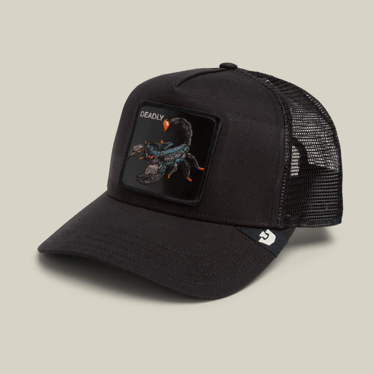 The Goorin Bros. Deadly Scorpion trucker hat features a black mesh back, a curved brim, and a front patch showcasing an intricate scorpion insignia with the word “DEADLY” above it. A logo tag decorates the side of the cap.