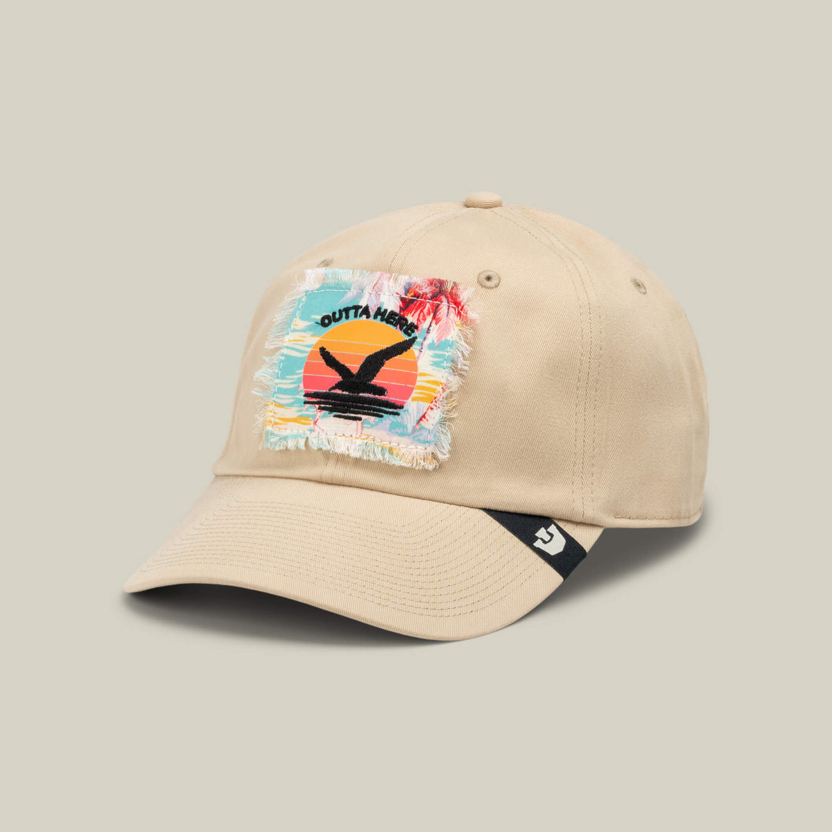 GTFO by Goorin Bros. is a beige baseball cap featuring a frayed patch with a sunset, palm trees, and bird silhouette, along with the bold text GTFO—a tribute to S.O.S. Island escapes. The brim edge displays a small black-and-white bird logo, making it the perfect cap for anyone eager to leave the mess hall behind and follow in Colonel Banu McGuven’s adventurous footsteps.