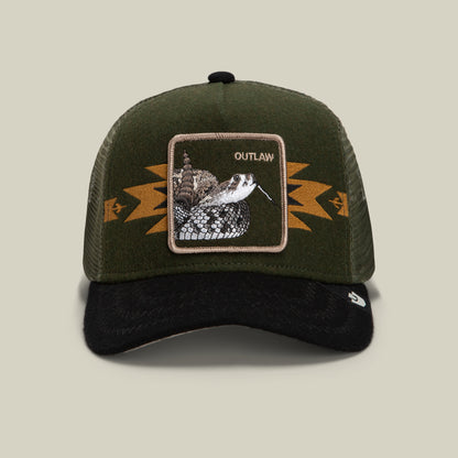Channel your outlaw energy with the Canyon Outlaw trucker hat by Goorin Bros.—a green and black wool blend cap with a breathable mesh back, bold geometric gold detailing, and a striking rattlesnake patch labeled OUTLAW on the front.