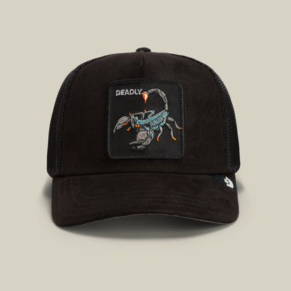 The Goorin Bros. Suede Scorpion is a black trucker hat featuring a suede front with a patch of a scorpion and the word “DEADLY” embroidered above it, complemented by a breathable mesh back and curved brim.