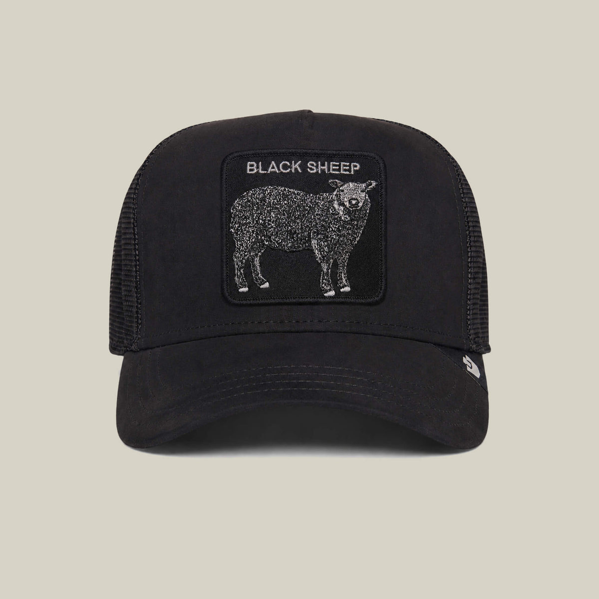 Introducing the Suede Sheep trucker hat by Goorin Bros.—a black-and-white cap with a suede finish, featuring a bold BLACK SHEEP patch above an illustrated black sheep.