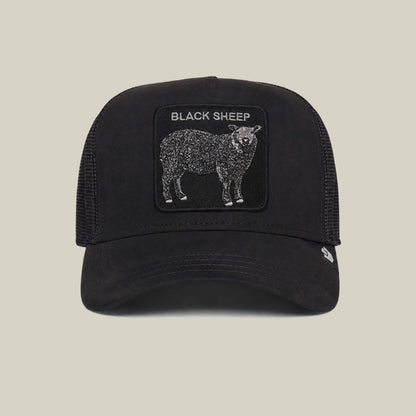 Introducing the Suede Sheep trucker hat by Goorin Bros.—a black-and-white cap with a suede finish, featuring a bold BLACK SHEEP patch above an illustrated black sheep.