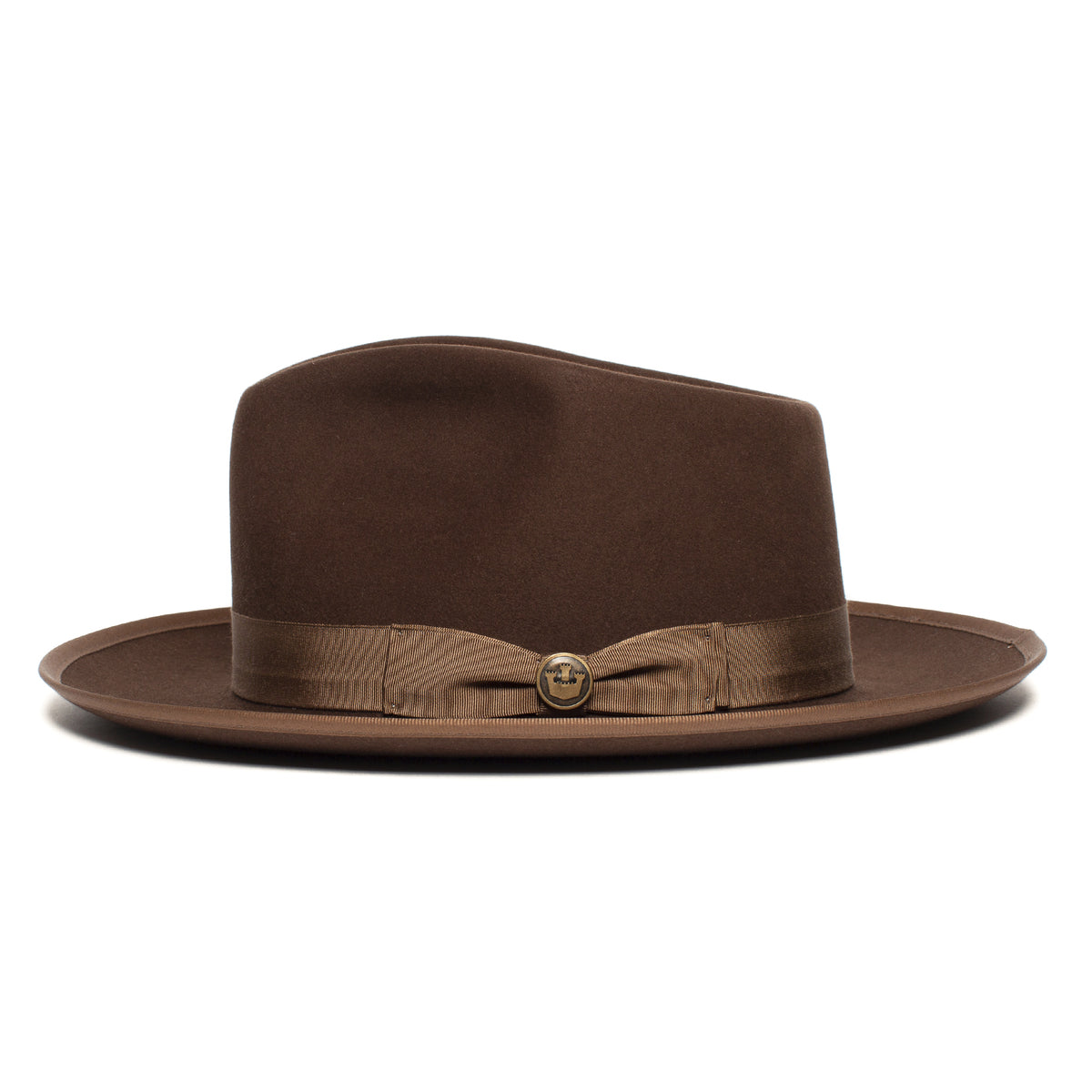 Introducing the River Gray by Goorin Bros.—a wide brim fedora in a sophisticated brown hue, styled with an indented crown and expertly crafted from soft merino wool. Accented with a brown ribbon band and a delicate side button, this American-made accessory blends timeless design with premium materials for a truly distinguished look.