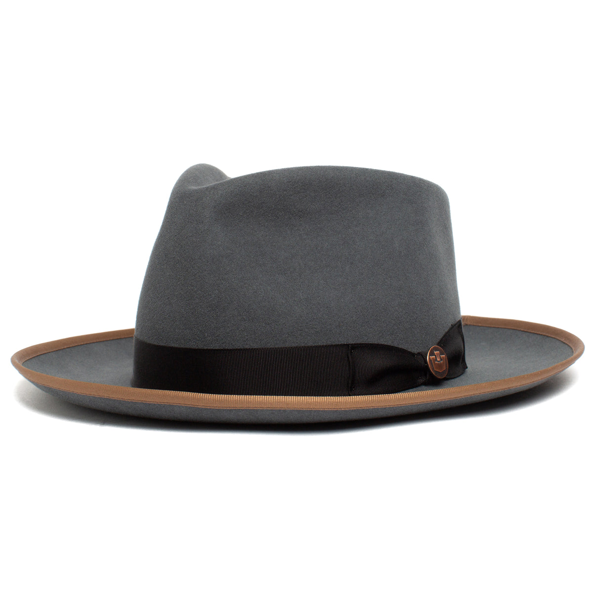 The River Gray by Goorin Bros. is an American-made wide brim fedora crafted from premium merino wool, featuring a brown edge trim and a black band with a small round emblem.