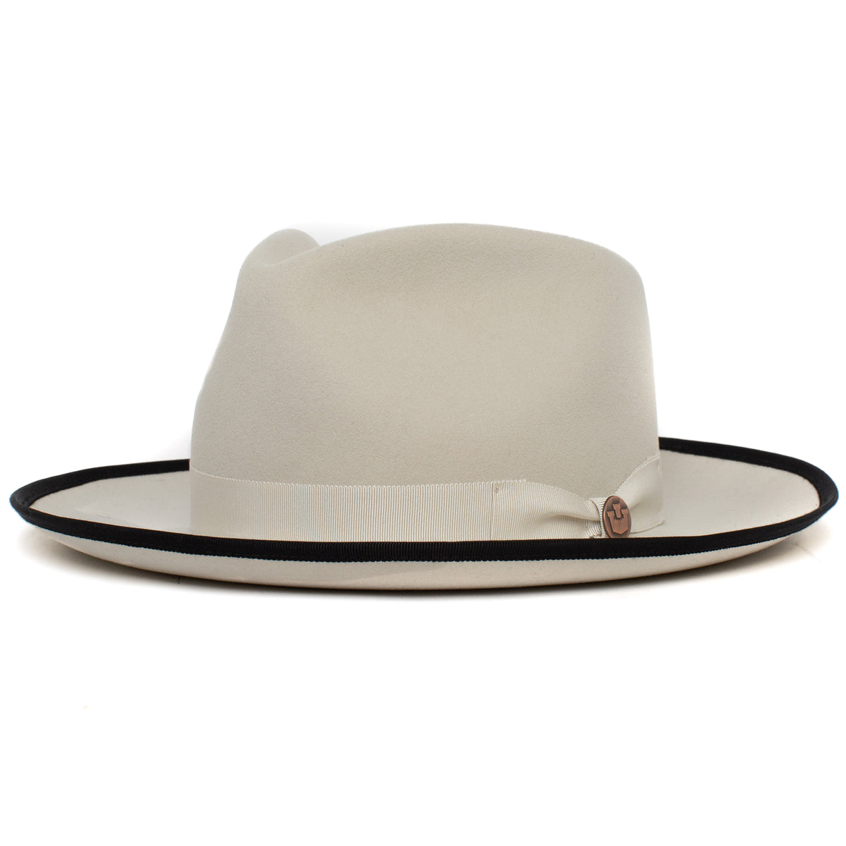 Introducing the River Gray by Goorin Bros.—an American-made, wide brim fedora crafted from soft merino wool in a light beige hue. This stylish hat features a black rim edge and is accented with a coordinating beige ribbon band around the crown.