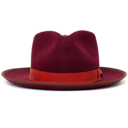 A wide brim fedora, the River Gray by Goorin Bros., is American made from premium merino wool, featuring a striking red grosgrain ribbon band and elegantly displayed against a white background.
