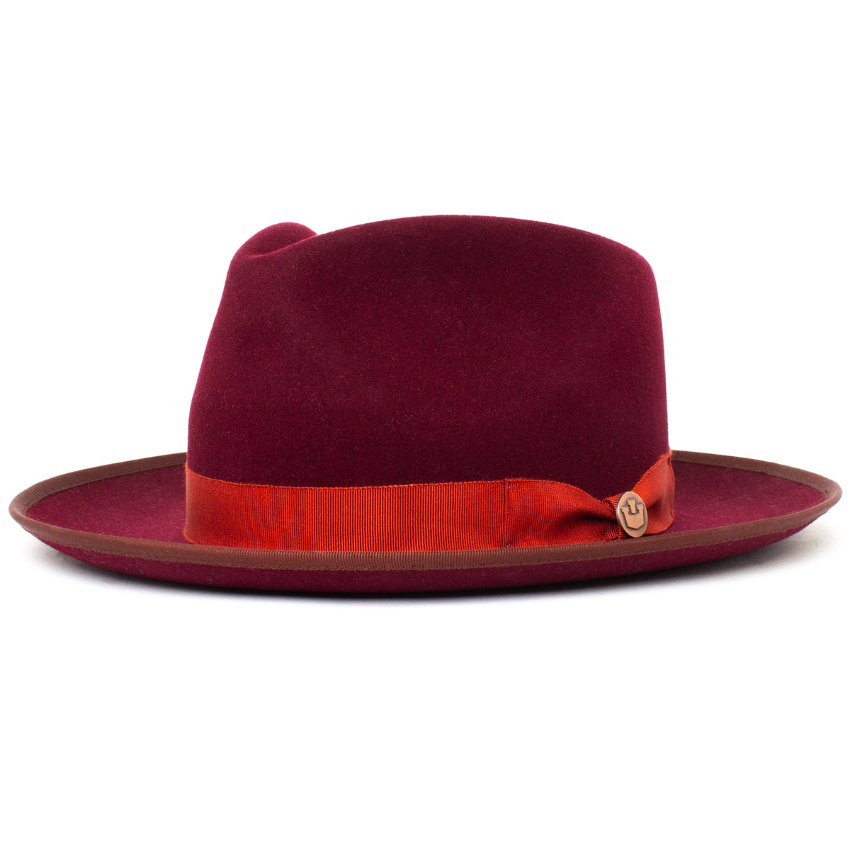 The River Gray by Goorin Bros. is an American-made fedora in burgundy merino wool, featuring a wide brim with a brown edge and adorned with a red ribbon band and a small round pin on the side.
