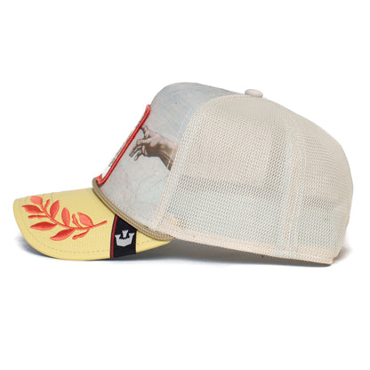 The Maximum hat by The Farm is a beige mesh trucker cap featuring a yellow brim, a red leaf design, a crown patch, and an image of a hand reaching out on the front panel. Please note: All Sales Are Final.